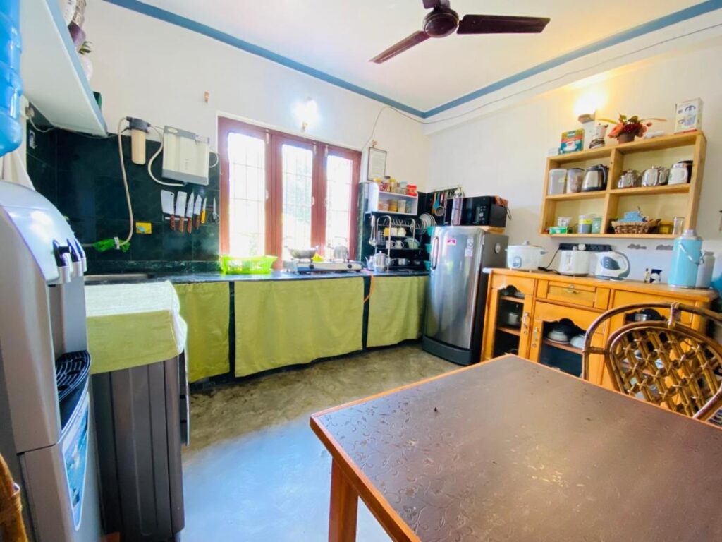 Experience Tibetan Rooms - Kitchen with dining table and a mini fridge